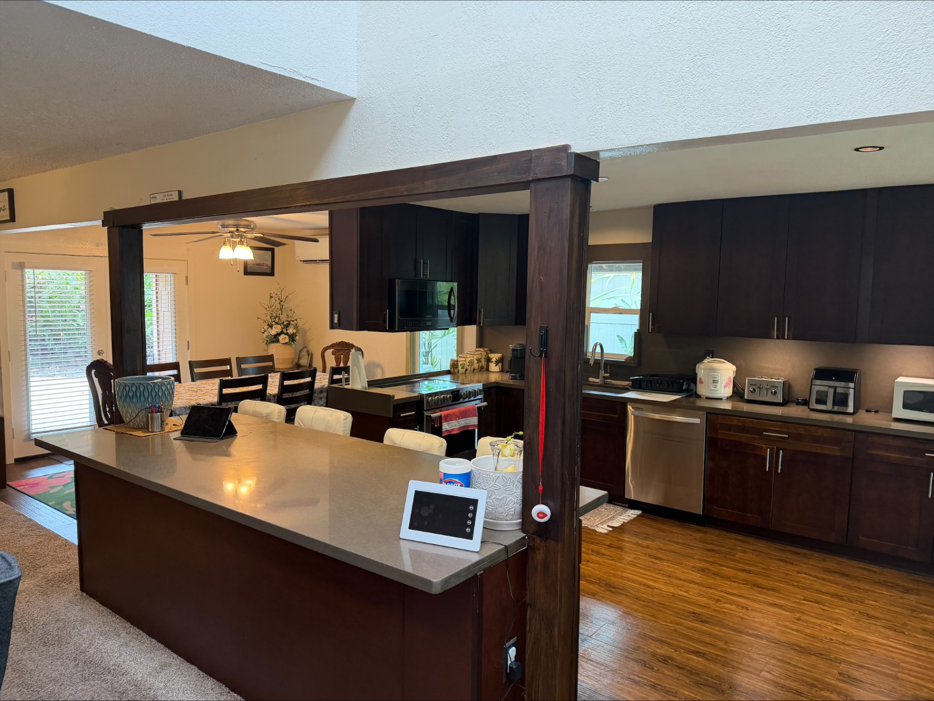 Open kitchen with breakfast bar and dining area beyond